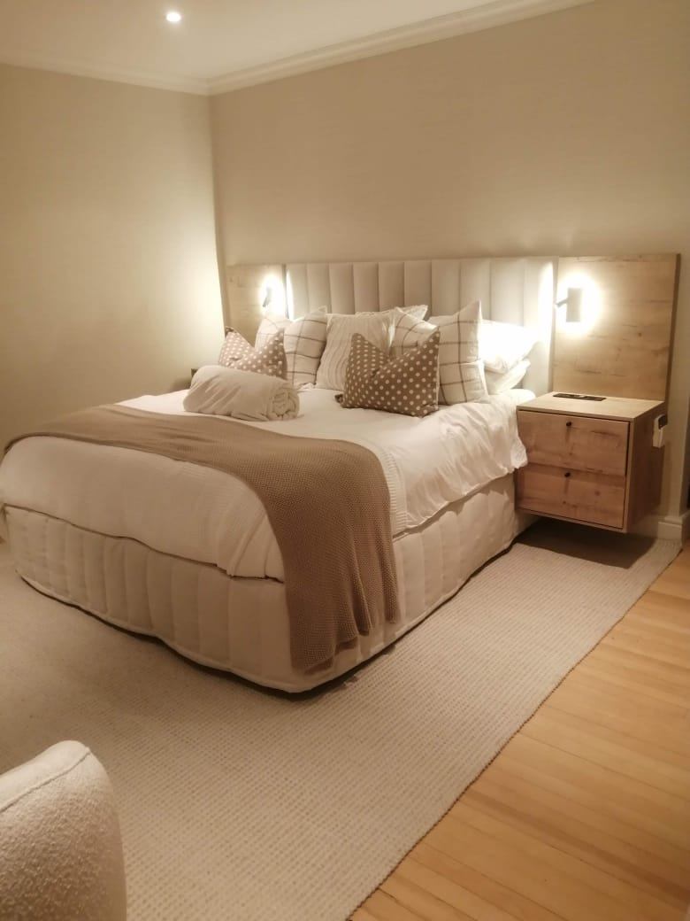 Bedroom headboard with built-in wall-mounted reading lights